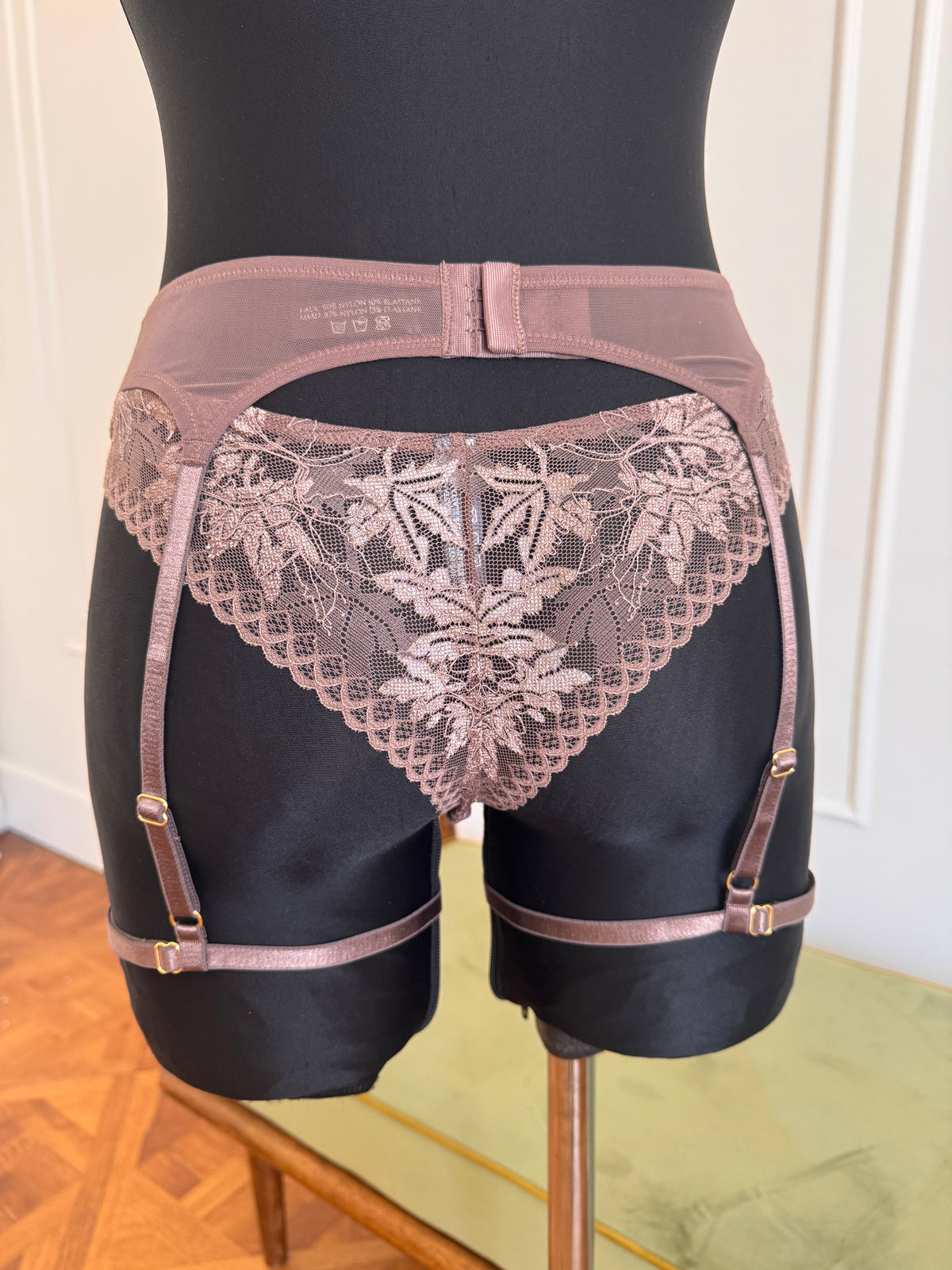 Juliette Suspender Belt in Mocha on a dress form, back view